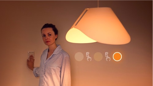 Woman switching the sceneswitch bulb to low brightness