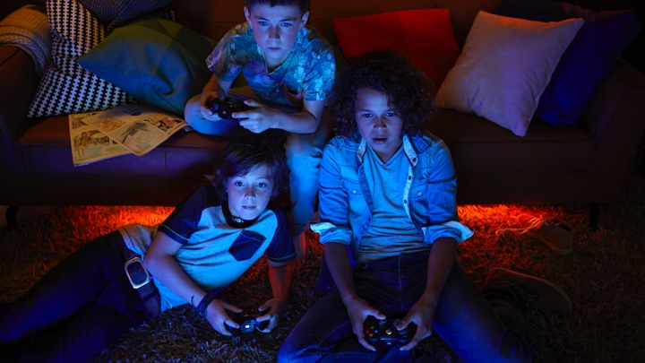 3 boys playing video games with ambiance lighting