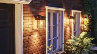 Modern LED outdoor wall sconce illuminates rustic wooden exterior, showcasing energy-efficient and weatherproof lighting solutions for contemporary home facades and porches.